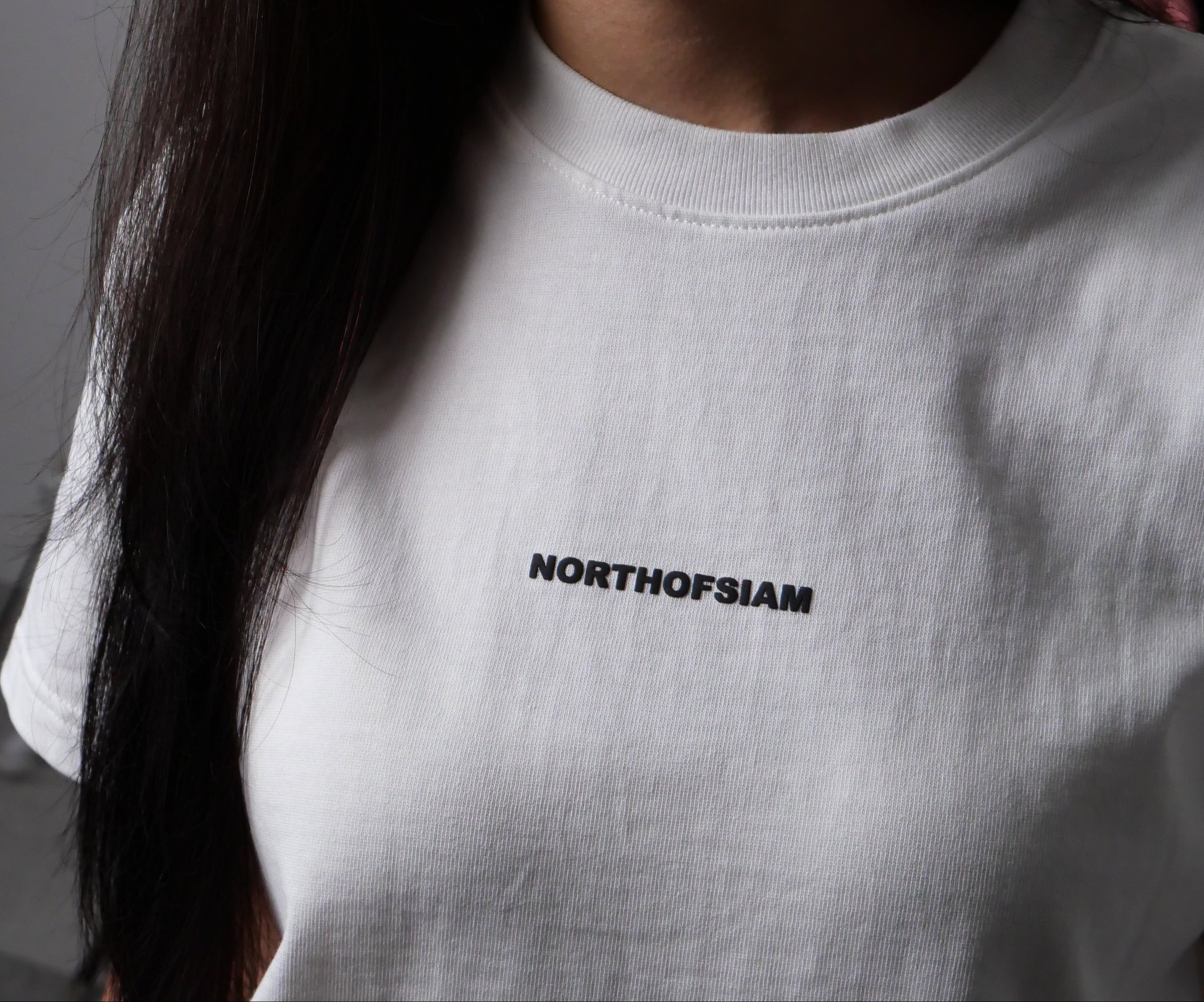 Person wearing a white t-shirt with 'NORTHAM' text on a dark background